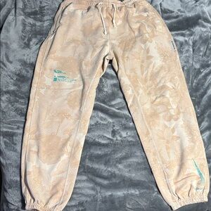 Nike Beige Joggers with Teal Logo